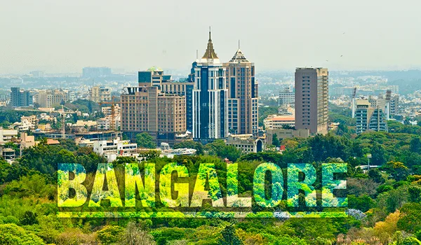 Bangalore city skyline with high-rise office and hotel towers rising above dense tree cover