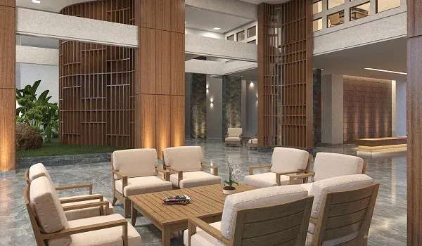Double-height clubhouse lounge with timber screens, stone columns and grouped armchairs around low tables