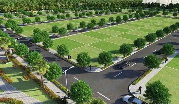 Marked-out residential plots in rows along tree-lined internal roads with street lighting and footpaths