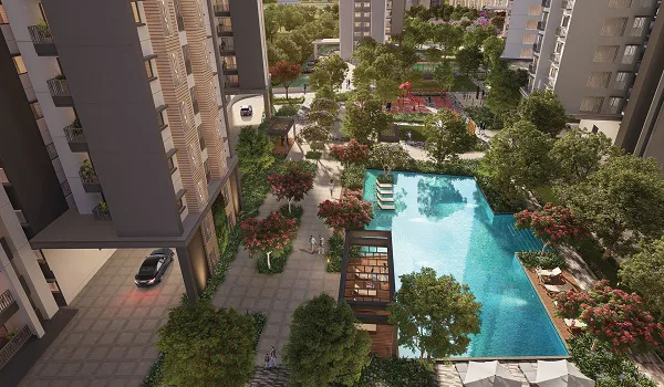 Aerial view of a landscaped swimming pool with poolside pavilion, sun deck and mature trees between apartment blocks